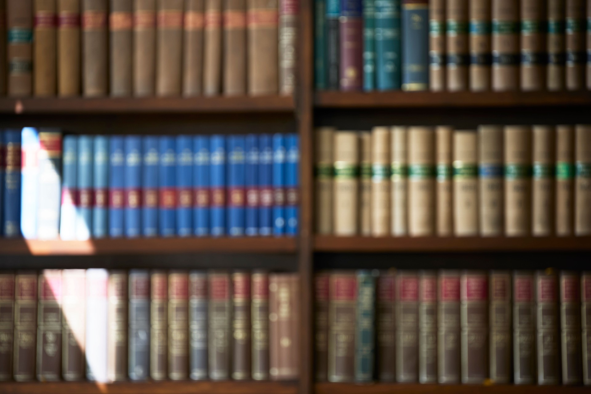 Defocused Shot Of Legal Books On Shelf In Office Of Lawyer Soliciitor Or Attorney